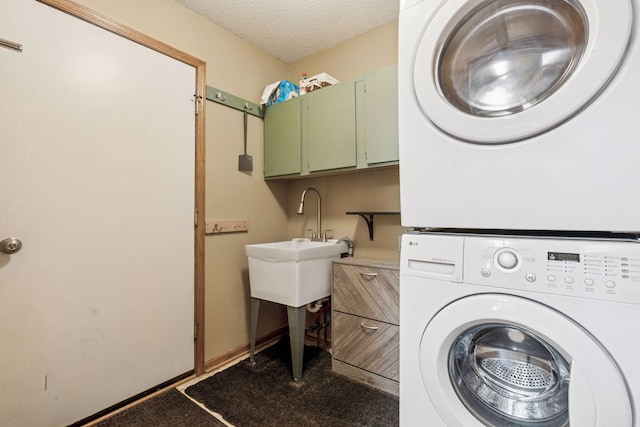 7140 Ivy Ridge Ct, Lino Lakes, MN 55014 - laundry area featuring estacked washer and dryer, cabinet space, and a textured ceiling