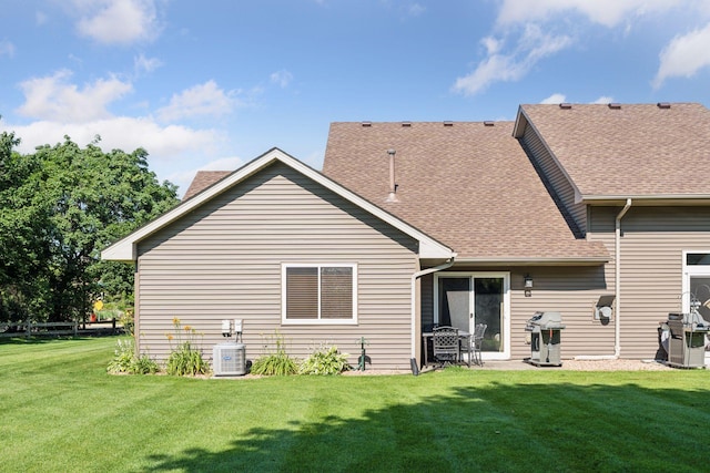 7140 Ivy Ridge Ct, Lino Lakes, MN 55014 - back of property with a yard, roof with shingles, and a patio area
