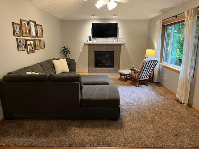 100 Barkley Cir W, Cannon Falls, MN 55009 - carpeted living room with a ceiling fan, a tiled fireplace, and vaulted ceiling