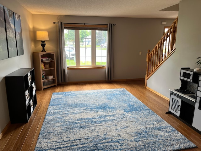 100 Barkley Cir W, Cannon Falls, MN 55009 - living area featuring wood finished floors, stairs, and a textured ceiling