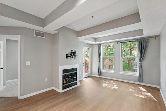 645 1st St Unit 305, Minneapolis, MN 55401 - unfurnished living room with wood finished floors, a fireplace, and a raised ceiling