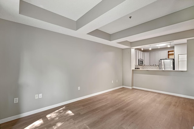 645 1st St Unit 305, Minneapolis, MN 55401 - unfurnished living room with wood finished floors and a raised ceiling