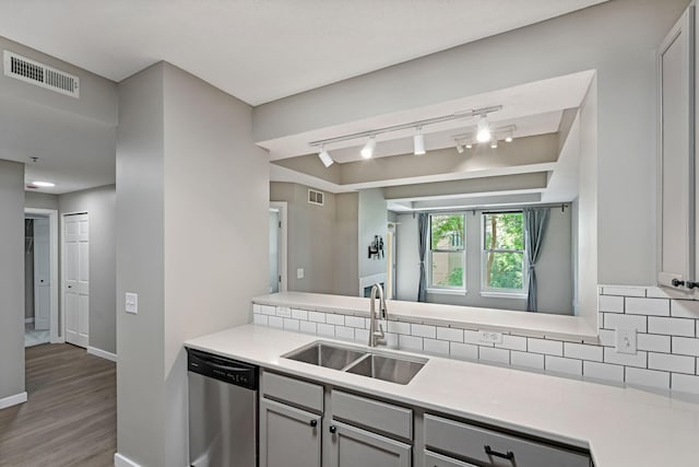 645 1st St Unit 305, Minneapolis, MN 55401 - kitchen with dishwasher, track lighting, wood finished floors, decorative backsplash, and light countertops