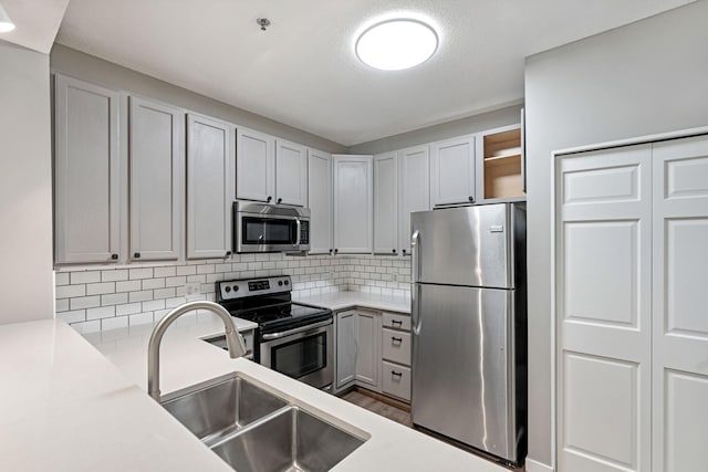 645 1st St Unit 305, Minneapolis, MN 55401 - kitchen with stainless steel appliances, decorative backsplash, light countertops, wood finished floors, and open shelves