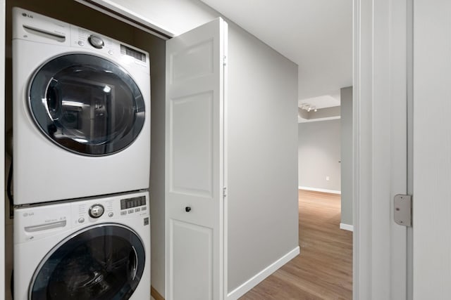 645 1st St Unit 305, Minneapolis, MN 55401 - laundry area with stacked washer and clothes dryer and light wood-type flooring
