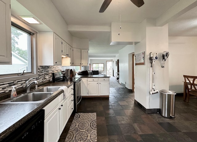 511 3rd St, Nashwauk, MN 55769 - kitchen featuring electric stove, black dishwasher, a peninsula, dark countertops, and backsplash