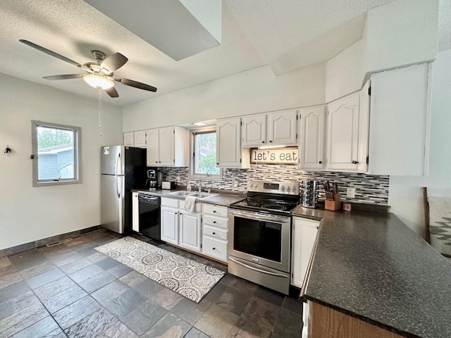 511 3rd St, Nashwauk, MN 55769 - kitchen featuring appliances with stainless steel finishes, decorative backsplash, dark countertops, a ceiling fan, and white cabinets