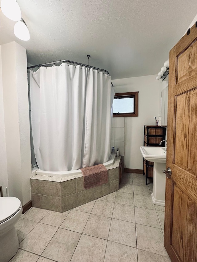 511 3rd St, Nashwauk, MN 55769 - bathroom with tile patterned flooring, a textured ceiling, and tiled shower / bath