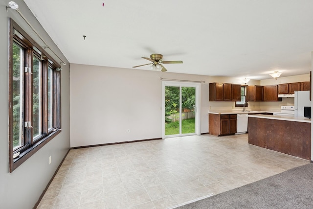 812 Ivanhoe Dr, Northfield, MN 55057 - kitchen with white appliances, light countertops, under cabinet range hood, a ceiling fan, and light tile patterned floors