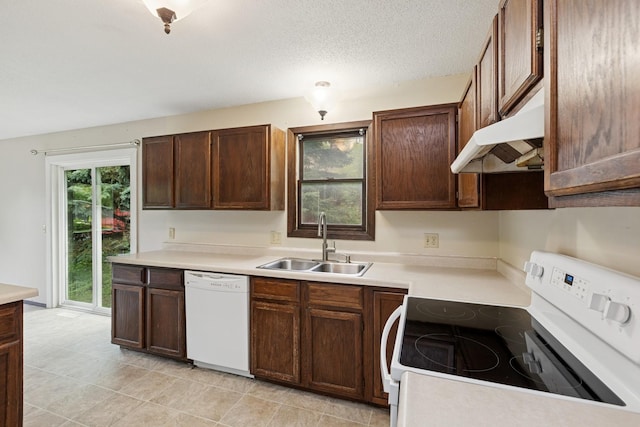 812 Ivanhoe Dr, Northfield, MN 55057 - kitchen with white appliances, under cabinet range hood, light countertops, and light tile patterned flooring