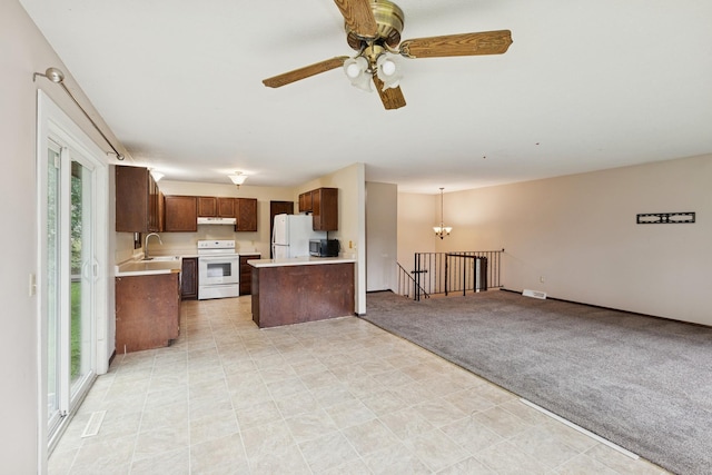 812 Ivanhoe Dr, Northfield, MN 55057 - kitchen with white appliances, open floor plan, light countertops, under cabinet range hood, and a ceiling fan
