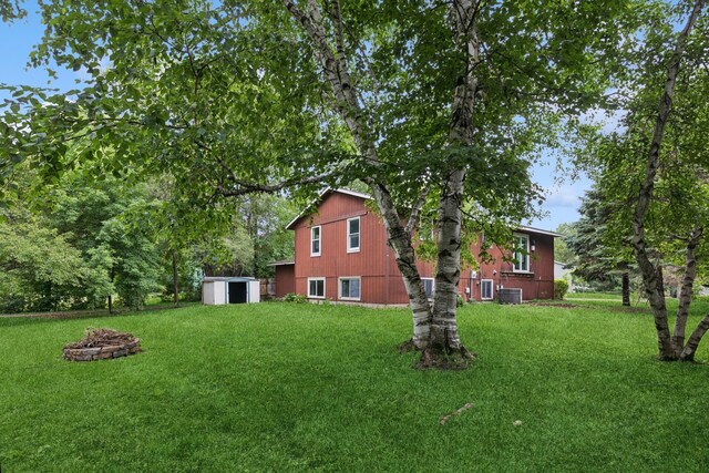 812 Ivanhoe Dr, Northfield, MN 55057 - view of green lawn featuring a shed and an outdoor fire pit