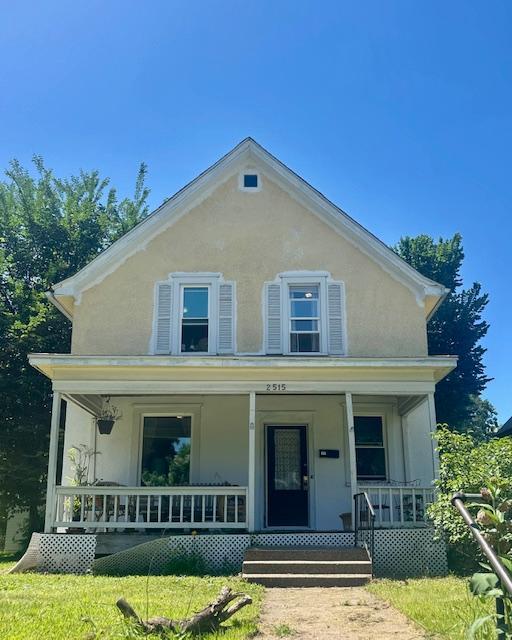2515 Logan Ave N, Minneapolis, MN 55411 - view of front facade with a porch and stucco siding