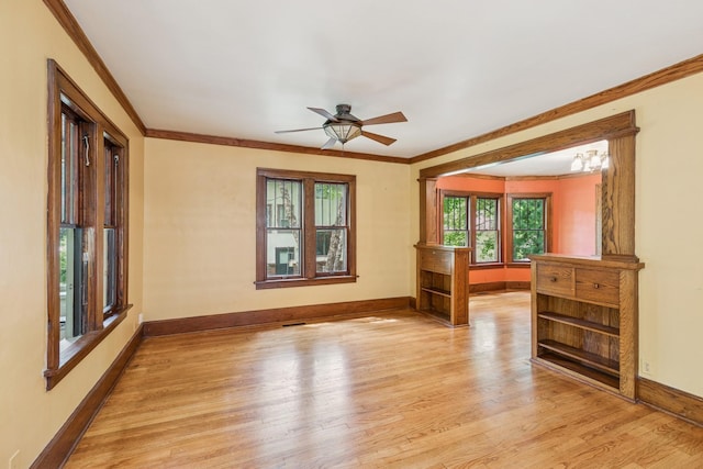 713 4th St E, Northfield, MN 55057 - spare room featuring light wood finished floors, ornamental molding, and a ceiling fan
