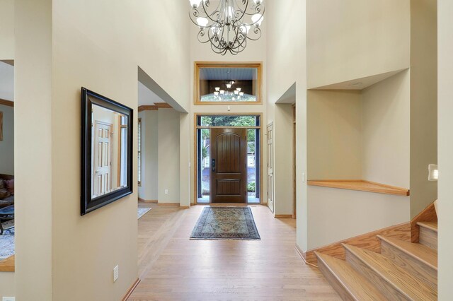 7569 Blackoaks Ln N, Maple Grove, MN 55311 - entrance foyer with a chandelier, a high ceiling, light wood-style flooring, and stairway