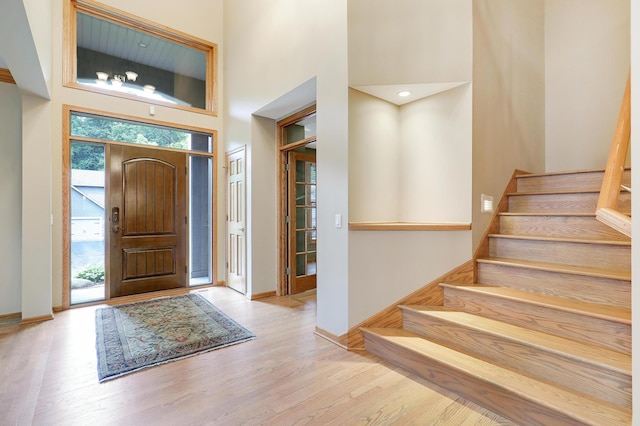 7569 Blackoaks Ln N, Maple Grove, MN 55311 - entrance foyer featuring healthy amount of natural light, stairway, wood finished floors, and a high ceiling