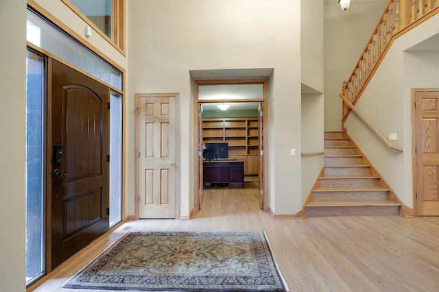 7569 Blackoaks Ln N, Maple Grove, MN 55311 - entryway featuring light wood finished floors, a towering ceiling, and stairs