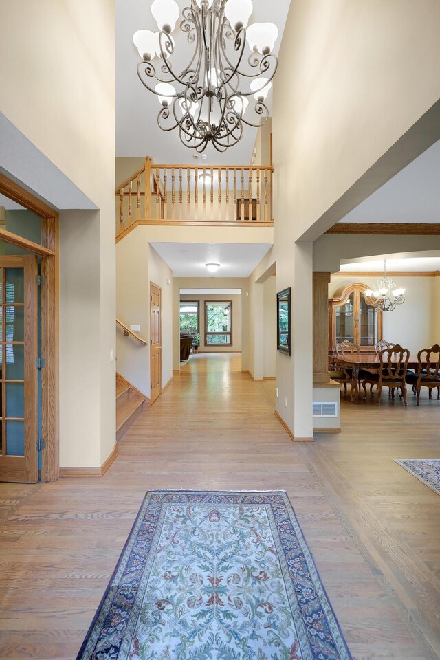 7569 Blackoaks Ln N, Maple Grove, MN 55311 - foyer entrance featuring a chandelier, stairs, wood finished floors, and a towering ceiling