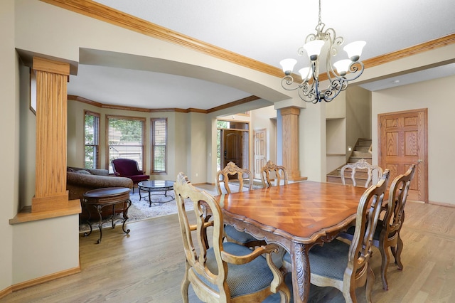 7569 Blackoaks Ln N, Maple Grove, MN 55311 - dining space with decorative columns, light wood-style floors, arched walkways, ornamental molding, and stairs