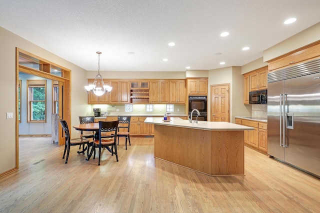 7569 Blackoaks Ln N, Maple Grove, MN 55311 - kitchen featuring black appliances, open shelves, light countertops, light wood finished floors, and recessed lighting