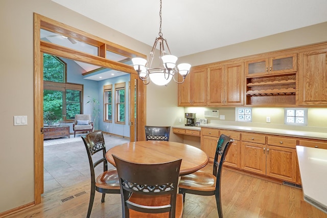 7569 Blackoaks Ln N, Maple Grove, MN 55311 - dining area with a chandelier, plenty of natural light, and light wood-style flooring