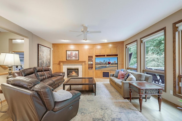 7569 Blackoaks Ln N, Maple Grove, MN 55311 - living area with a ceiling fan, light wood-type flooring, and a tiled fireplace