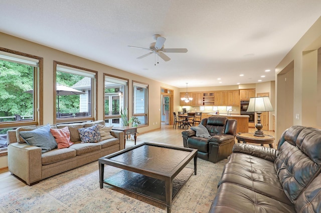 7569 Blackoaks Ln N, Maple Grove, MN 55311 - living room with light wood-type flooring, a ceiling fan, a chandelier, and recessed lighting