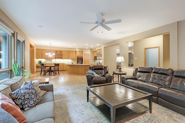 7569 Blackoaks Ln N, Maple Grove, MN 55311 - living area with a chandelier, light wood-style floors, a ceiling fan, and recessed lighting