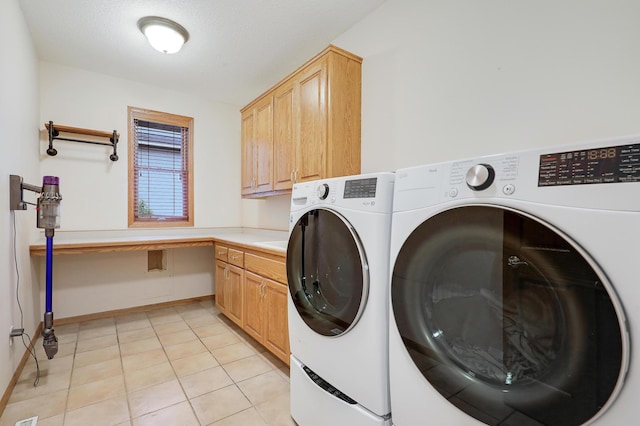 7569 Blackoaks Ln N, Maple Grove, MN 55311 - laundry area with washing machine and clothes dryer, cabinet space, and light tile patterned flooring