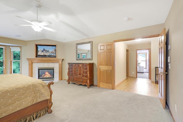 7569 Blackoaks Ln N, Maple Grove, MN 55311 - bedroom with multiple windows, carpet floors, lofted ceiling, a tiled fireplace, and a ceiling fan