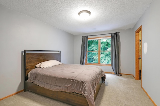 7569 Blackoaks Ln N, Maple Grove, MN 55311 - bedroom featuring a textured ceiling and light colored carpet