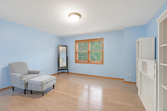 7569 Blackoaks Ln N, Maple Grove, MN 55311 - living area featuring light wood-style flooring and a textured ceiling