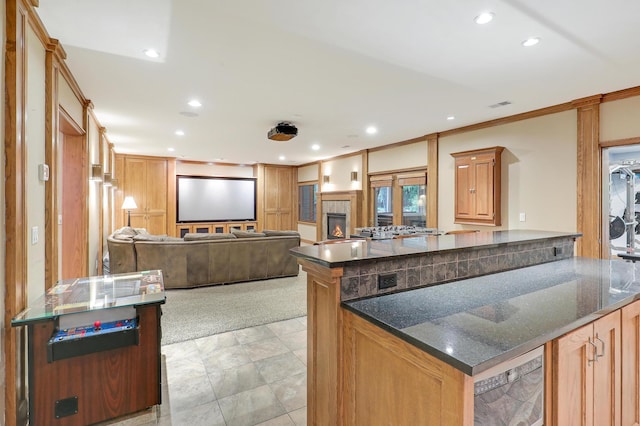 7569 Blackoaks Ln N, Maple Grove, MN 55311 - kitchen with recessed lighting, open floor plan, dark stone countertops, a fireplace, and a peninsula