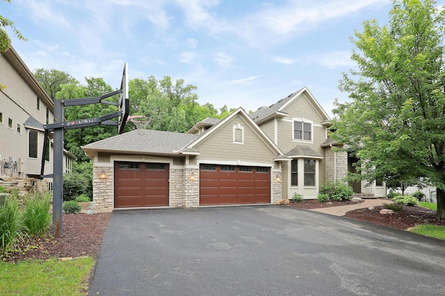 7569 Blackoaks Ln N, Maple Grove, MN 55311 - view of front of house featuring stone siding, driveway, and an attached garage