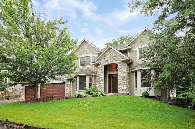 7569 Blackoaks Ln N, Maple Grove, MN 55311 - view of front of house with stone siding, a front lawn, a garage, and driveway