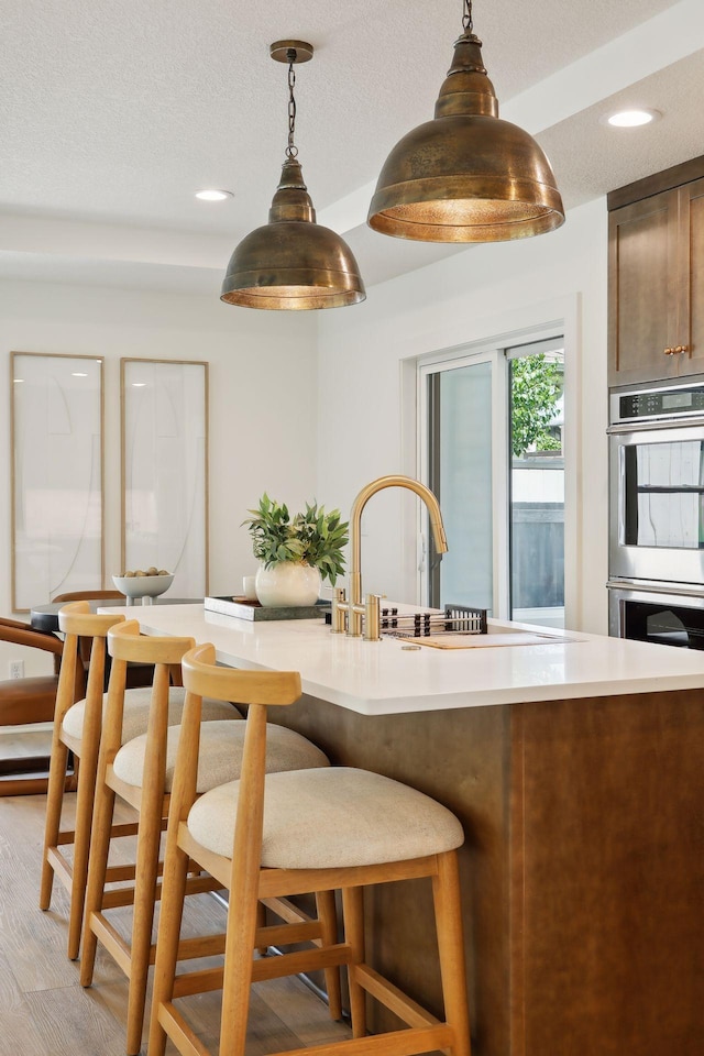 3520 27th Ave S, Minneapolis, MN 55406 - kitchen with double oven, pendant lighting, recessed lighting, light countertops, and light wood-style floors