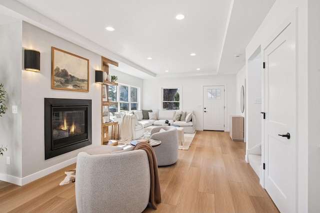3520 27th Ave S, Minneapolis, MN 55406 - living area with light wood-style flooring, a glass covered fireplace, recessed lighting, and a tray ceiling