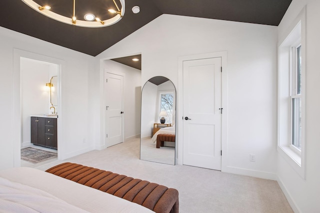 3520 27th Ave S, Minneapolis, MN 55406 - bedroom with lofted ceiling, arched walkways, light carpet, connected bathroom, and a chandelier