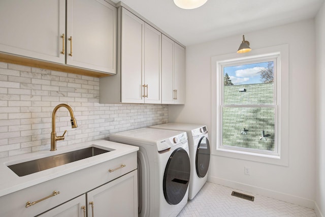 3520 27th Ave S, Minneapolis, MN 55406 - washroom with cabinet space, washing machine and clothes dryer, and tile patterned floors