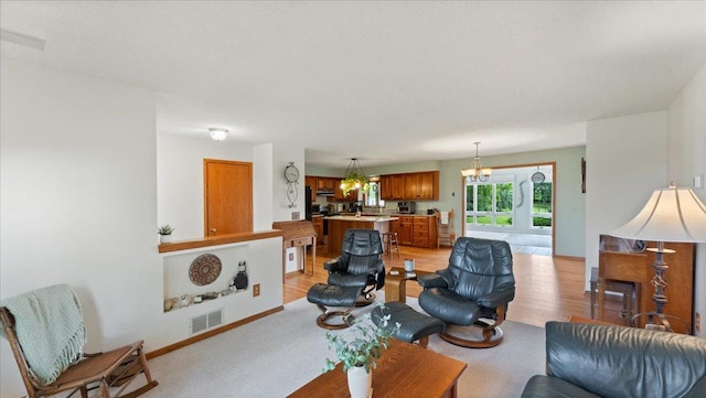 13867 85th St SW, Stockholm Twp, MN 55321 - living area featuring a chandelier and baseboards