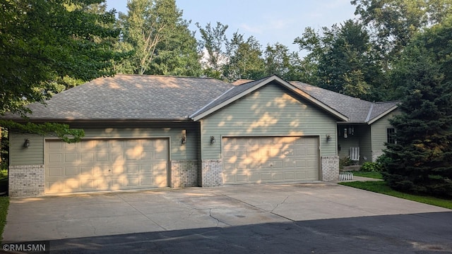 21021 Fresno St NW, Elk River, MN 55330 - view of front facade with brick siding, driveway, a garage, and a shingled roof