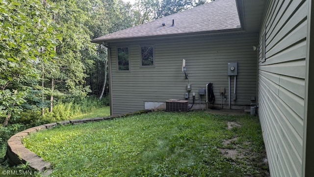 21021 Fresno St NW, Elk River, MN 55330 - view of side of home featuring roof with shingles and a lawn