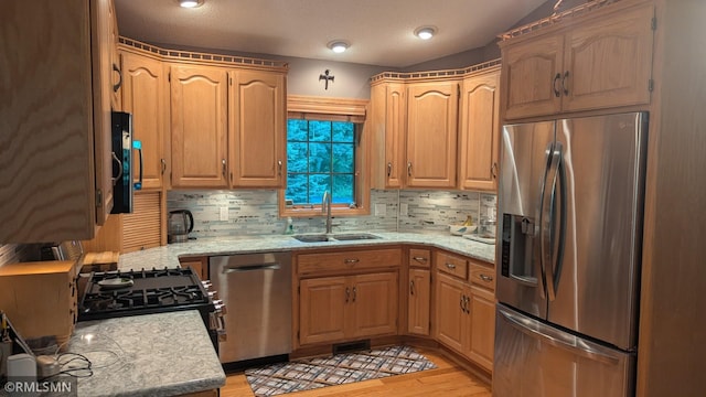 21021 Fresno St NW, Elk River, MN 55330 - kitchen featuring stainless steel appliances, backsplash, light wood-style flooring, and light stone countertops