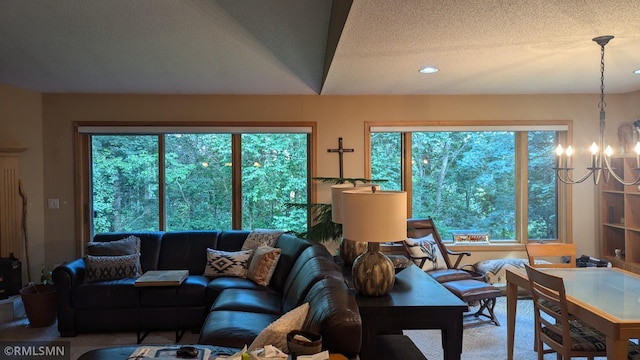 21021 Fresno St NW, Elk River, MN 55330 - carpeted living room with a chandelier, plenty of natural light, and a textured ceiling