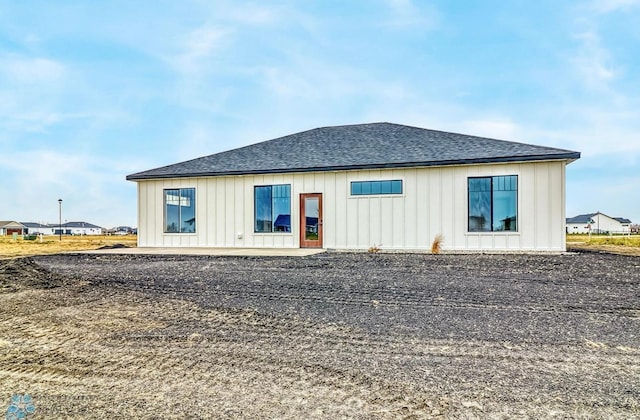 215 Emma Ct, Mapleton, ND 58059 - back of house featuring a shingled roof, board and batten siding, and a patio area