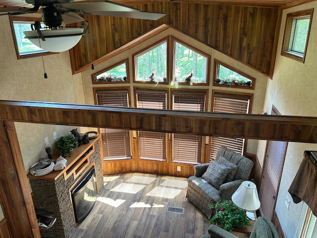 29156 State Highway 47, Aitkin, MN 56431 - sitting room with a ceiling fan, wood finished floors, a stone fireplace, and a textured wall