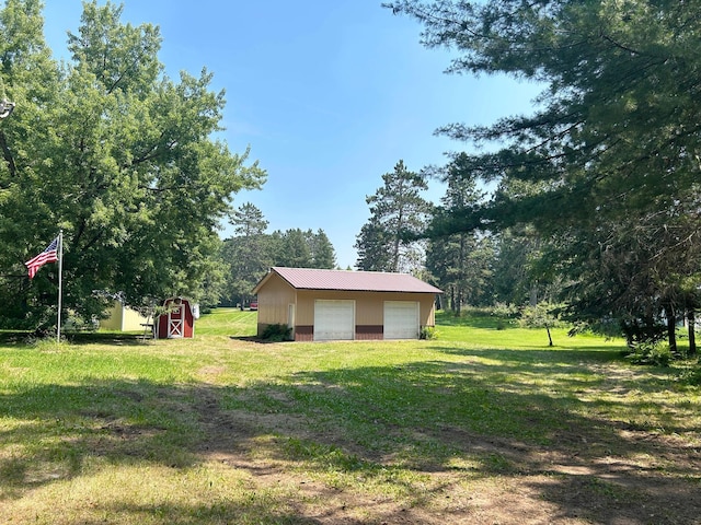 29156 State Highway 47, Aitkin, MN 56431 - view of grassy yard featuring an outbuilding, a detached garage, and driveway