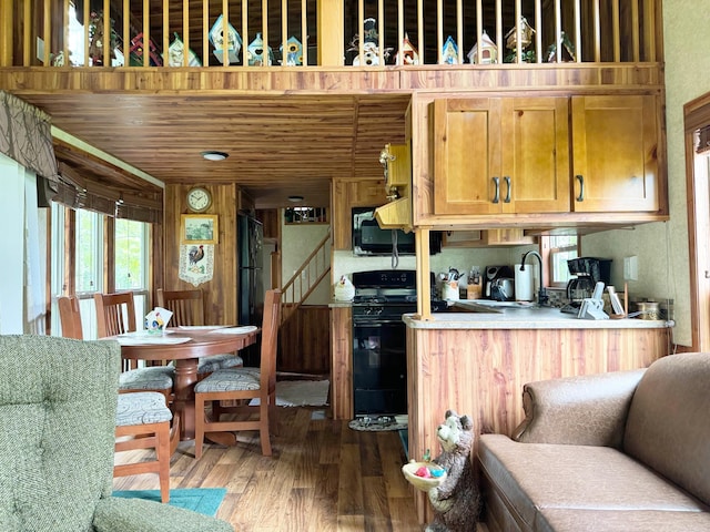 29156 State Highway 47, Aitkin, MN 56431 - kitchen featuring black appliances and wood finished floors