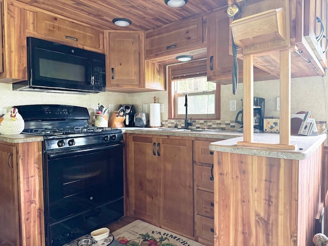 29156 State Highway 47, Aitkin, MN 56431 - kitchen featuring black appliances, light countertops, brown cabinetry, wooden ceiling, and tasteful backsplash