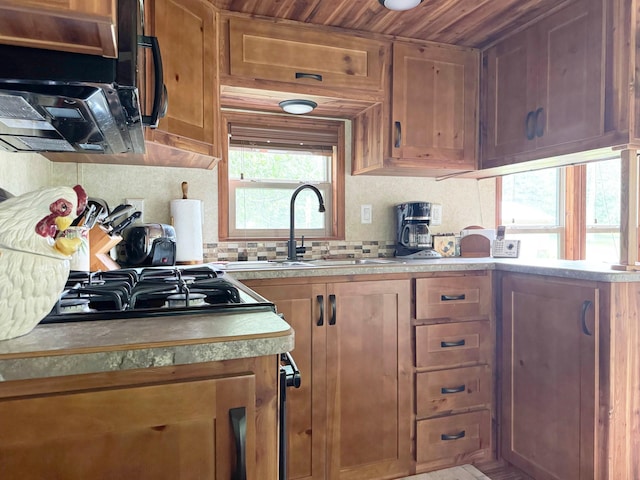 29156 State Highway 47, Aitkin, MN 56431 - kitchen featuring decorative backsplash, light countertops, exhaust hood, healthy amount of natural light, and wood ceiling